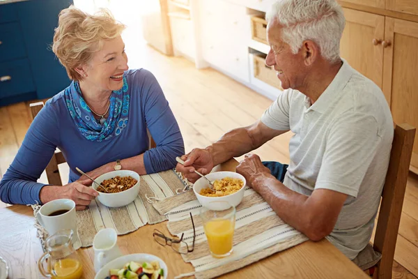 stock image Breakfast time is a great time to bond. a happy mature couple having breakfast together in their kitchen at home