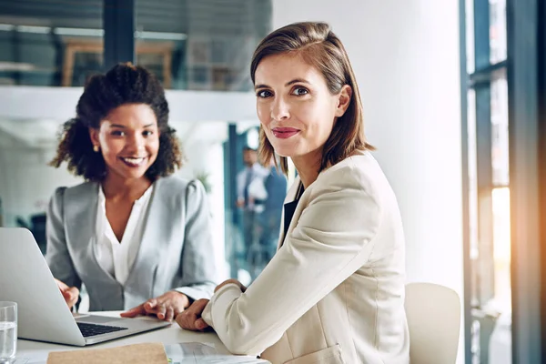 stock image Were not referred to as dynamic for nothing. Portrait of a two corporate businesswomen working together in an office