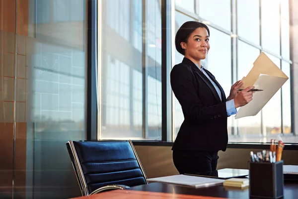 stock image Shes a dreamer and a doer. a young female lawyer standing by her desk in the office