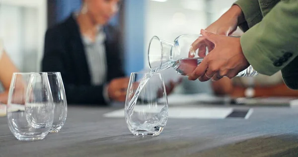 stock image Business staff, hands and pouring water into glass of a employee ready for a meeting. Drink, office workers and conference room table with employee group and strategy documents for discussion.