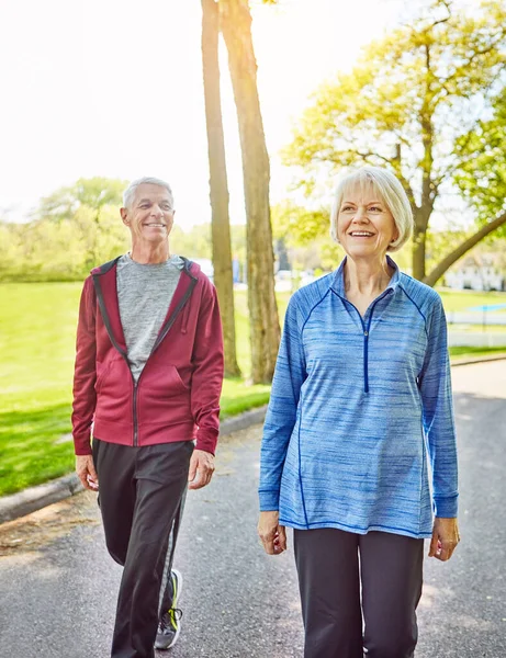 stock image Their life has been a walk in the park. an affectionate senior couple taking a walk in the park during the summer