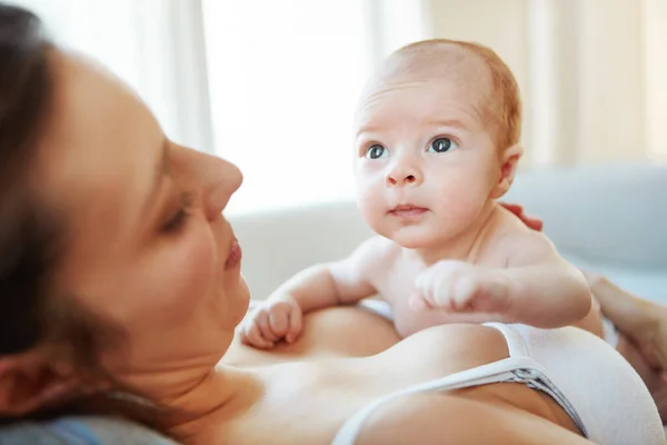 stock image Too cute for words. Closeup shot of a mother lying down with her newborn baby on top of her