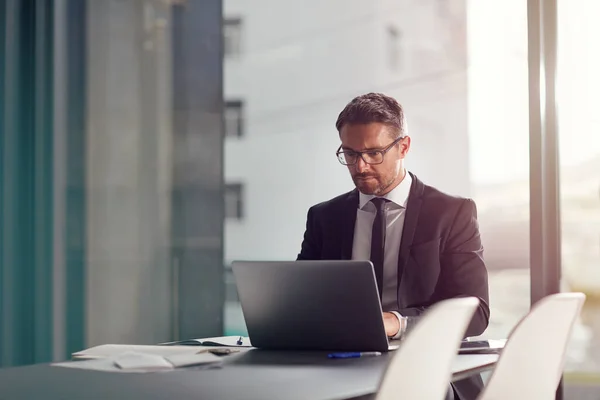 stock image Making some digital notes. a businessman working on a laptop in an office