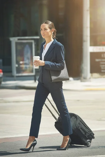 Taking the business world in her stride. a young businesswoman on the move in the city