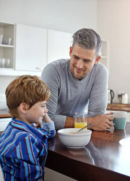 stock image Breakfast is better with family. a mid adult man and his son at home in the morning