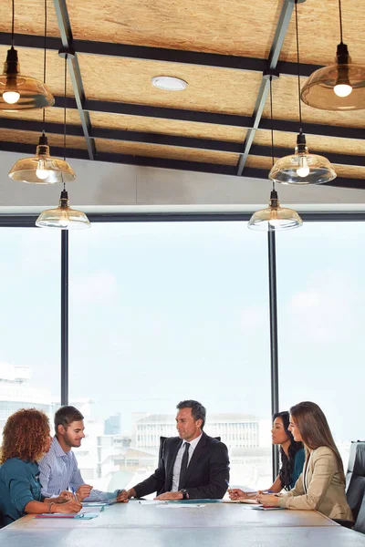 stock image The teams talking strategy. a group of businesspeople in a meeting