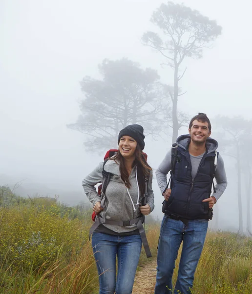 stock image Hiking is a workout with a view. a young couple enjoying a hike through nature