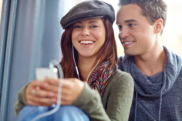 stock image He only has eyes for her. Portrait of happy couple listening to music on their phone