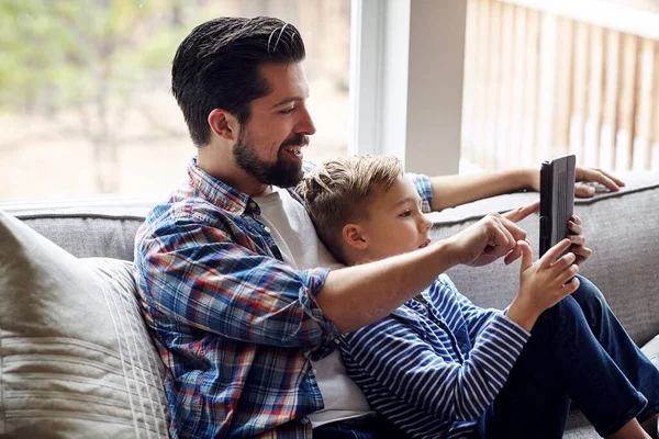 stock image Teaching his son all about the wonderful wireless world. a little boy using a digital tablet with his father at home