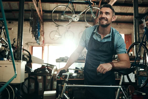 Determined to provide a premium bicycle repair service. a mature man working in a bicycle repair shop