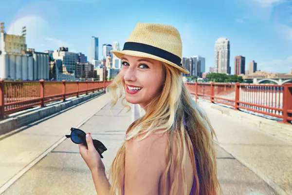 stock image Wanderlust and city dust. a smiling young woman walking around the city in the summertime