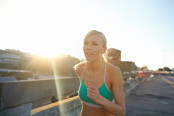 stock image One foot in front of the other. an attractive young woman enjoying her morning run