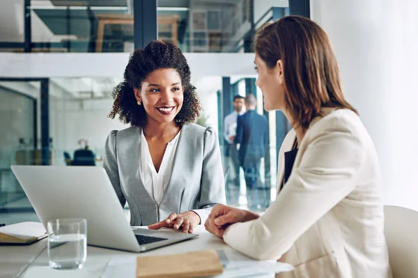 stock image Their expertise combined makes for powerful results. two corporate businesswomen having a discussion in an office