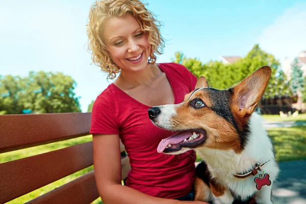 好可爱的小狗在公园里和她的狗亲近的年轻女人 — 图库照片