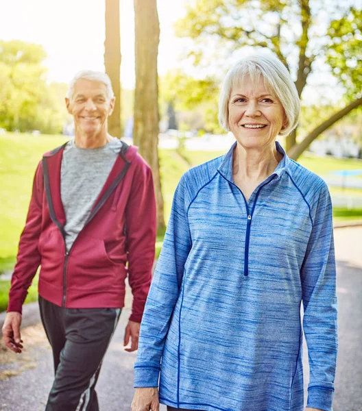 stock image Its a walk in the park. an affectionate senior couple taking a walk in the park during the summer