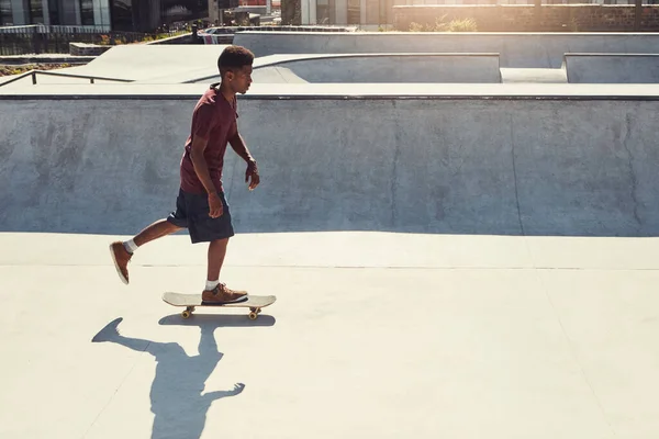 常に動き続けなさい スケートパークでスケートボードでトリックをやっている若い男の完全な長さのショット — ストック写真