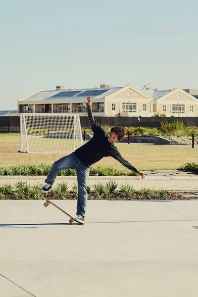 バランスは人生のすべてです スケートパークでスケートボードでトリックをやっている若い男の完全な長さのショット — ストック写真