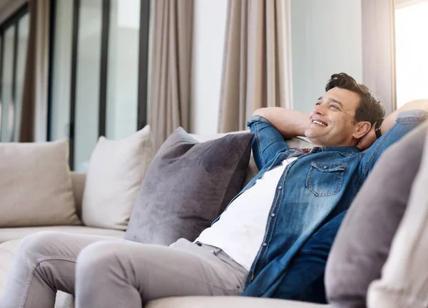 stock image More weekend please. a happy young man relaxing on the sofa at home