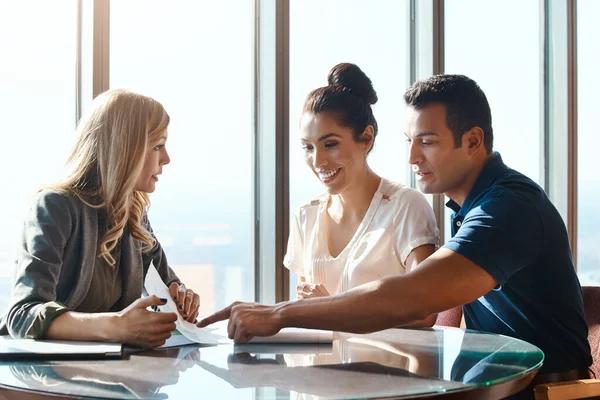 stock image The right monetary advice makes makes all the difference. a young couple meeting with a financial planner in a modern office