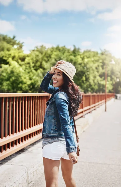 stock image Its time to explore. a beautiful young woman looking over her shoulder while out for a walk