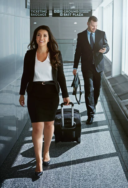 Pack your best suit, its time for a business trip. two executive businesspeople walking through an airport during a business trip