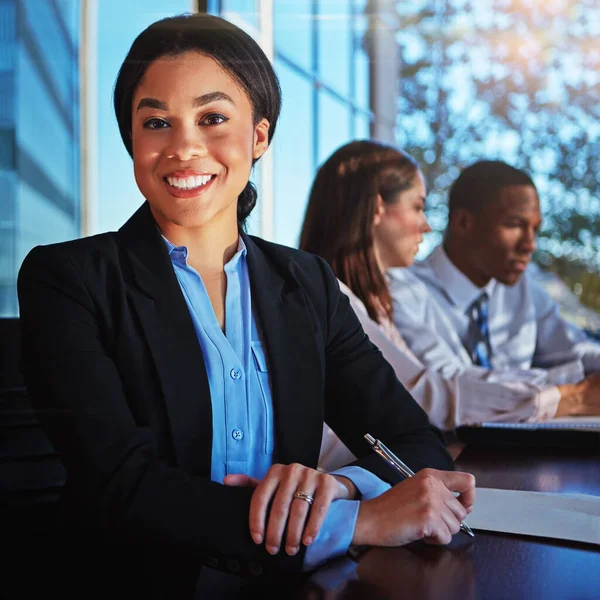 Stock image Taking our ideas to the boardroom. Cropped portrait of a young businesswoman sitting in a meeting with her boardroom