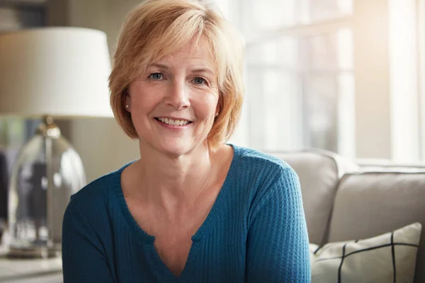 stock image Retiring in comfort, just the way I wanted. Portrait of a happy mature woman relaxing on the sofa at home