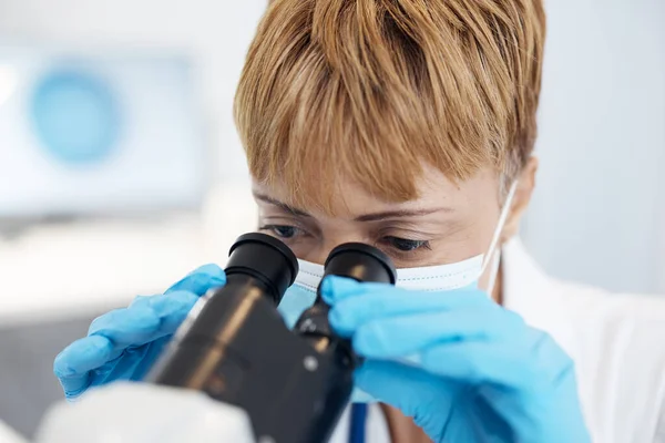 stock image Woman, scientist and microscope in forensics for discovery, breakthrough or scientific research in lab. Female medical professional or expert in healthcare or science examination or experiment.