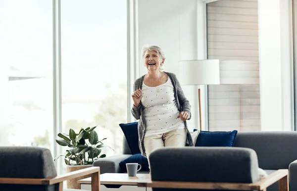 stock image Its not about how old you are but how you feel. a senior woman dancing at home