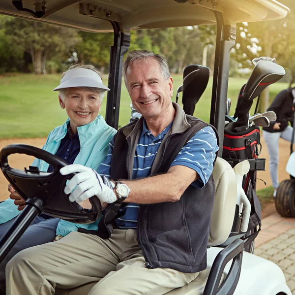 Out for a day on the green. Portrait of a smiling senior couple riding in a cart on a golf course
