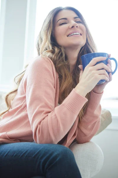 stock image A cup of coffee wakes me up for a beautiful day. a beautiful young woman having coffee while relaxing at home