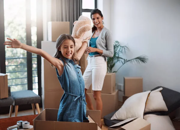 The most important package of all. an attractive young woman and her daughter moving into a new house