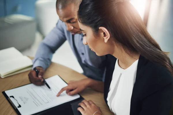 stock image Running through the big contract. two businesspeople going through some paperwork in an office