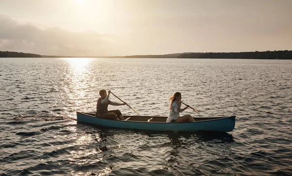 stock image The lake is where we fell in love. a young couple rowing a boat out on the lake