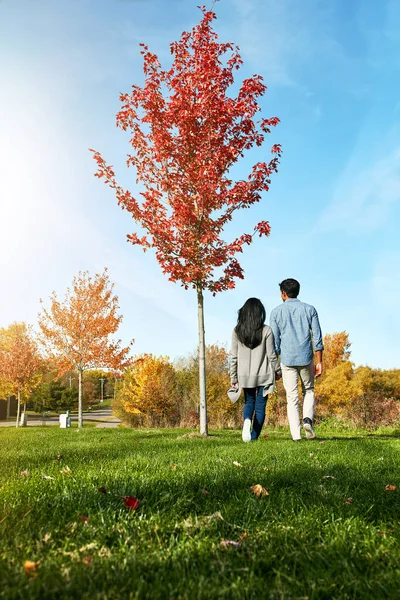 stock image Life is better with someone you love by your side. a loving young couple out for a walk in the park