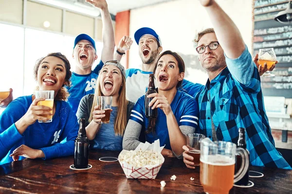 stock image Match day madness. a group of friends cheering while watching a sports game at a bar