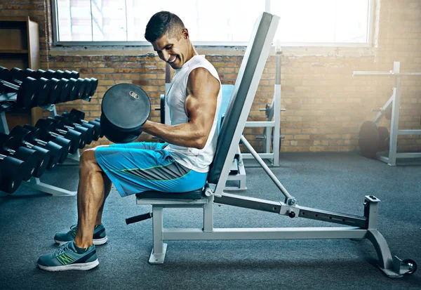 stock image Consistency births results. a young man working out alone in the gym