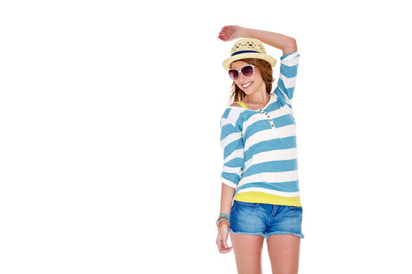 Carefree summer style. Studio shot of a young woman dressed for summer isolated on white