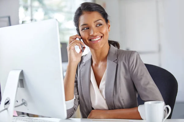 stock image She values her clients. a young businesswoman talking on the phone while sitting at her office desk