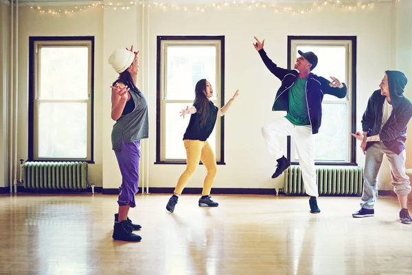 Stock image Dance moves that are all kinds of awesome. a group of young friends dancing together in a studio