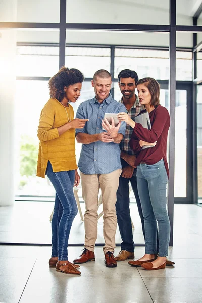 stock image Technology that allows for improved productivity. a team of designers working together on a digital tablet in an office