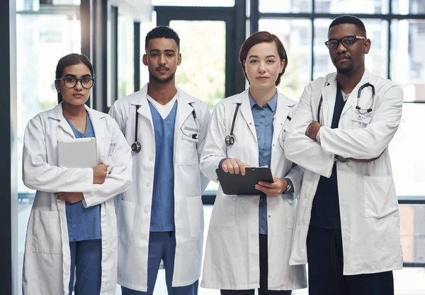 Stock image The medical field is amazing. a group of doctors standing in a row together at work