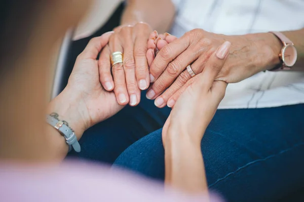 Stock image A challenge shared. a two unrecognizable people holding hands in support of one another