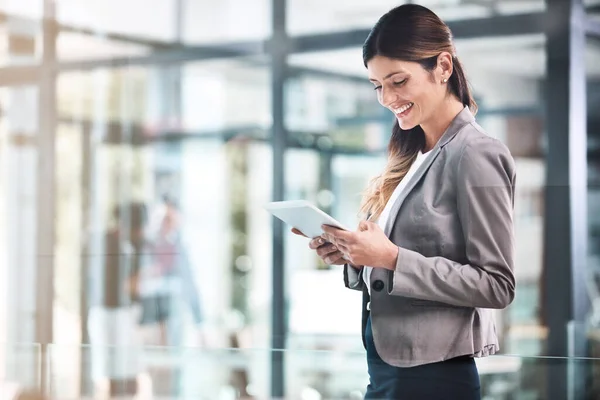 stock image Doing business in the digital age. a young businesswoman using a digital tablet in a modern office