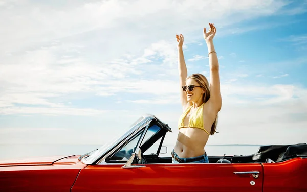 stock image Make life a permanent vacation. a happy young woman enjoying a summers road trip