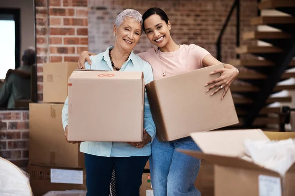 stock image Time to fill a new home with memories. a senior woman moving house with help from her daughter