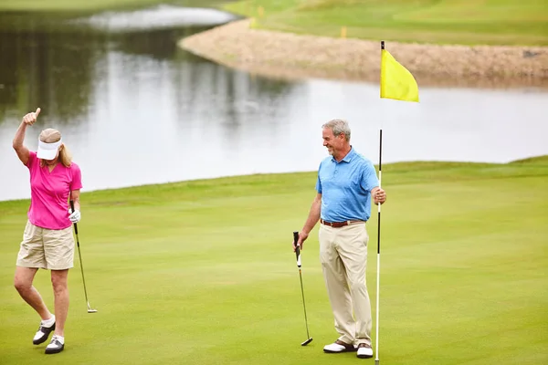 stock image Shes ready for a good game. a mature couple out playing golf together