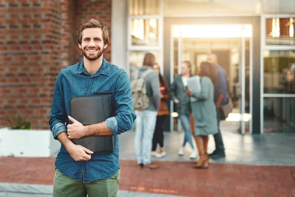 stock image Im here for the knowledge. Portrait of a happy young man standing outdoors on campus