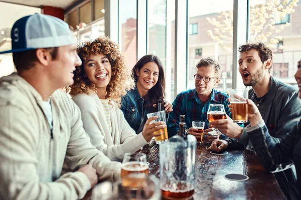 stock image Friends know just how to cheer you up. a group of friends enjoying themselves at a bar