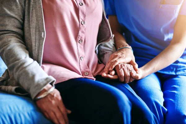 stock image Im here to make things better. a nurse holding a senior womans hands in comfort